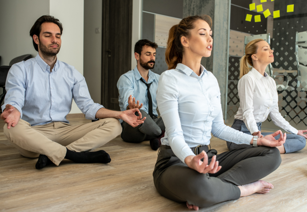 workmates meditating in the office