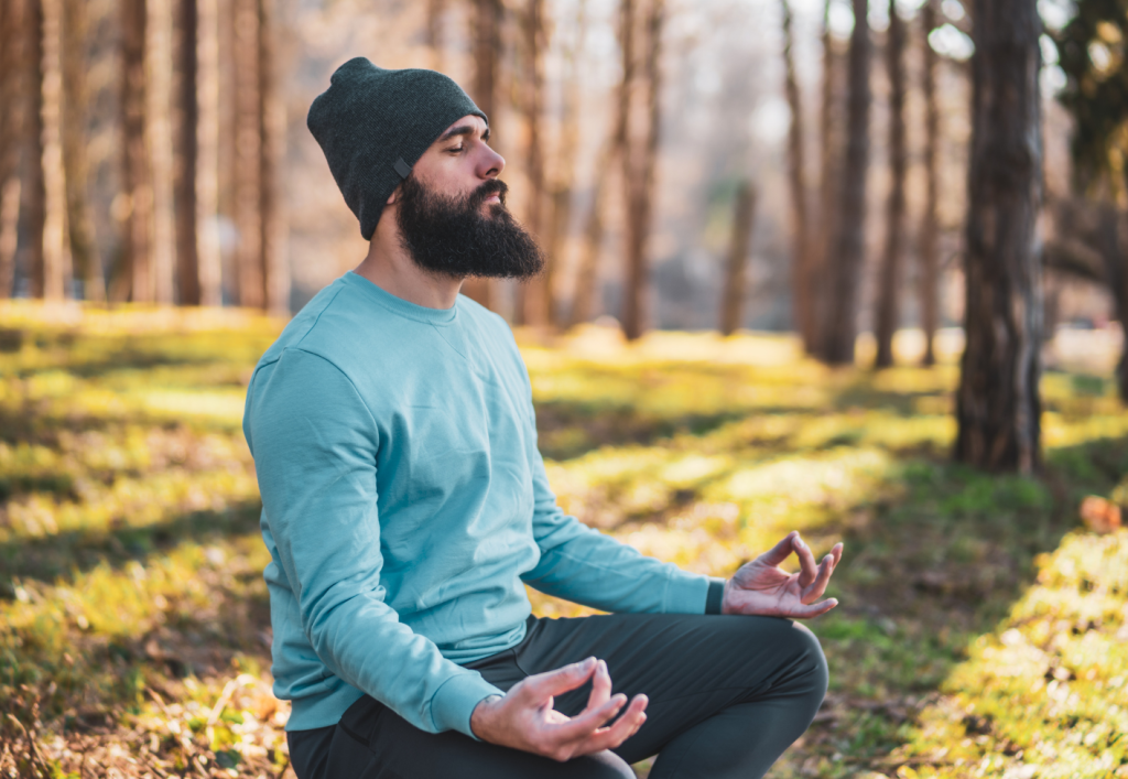 man meditating in the forest